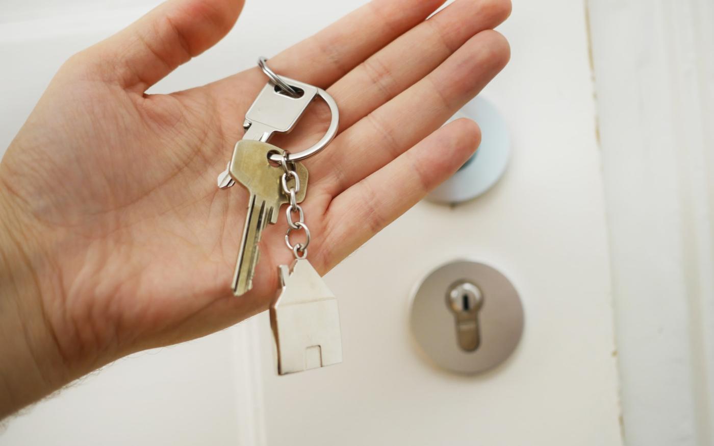 Hand holding a house key